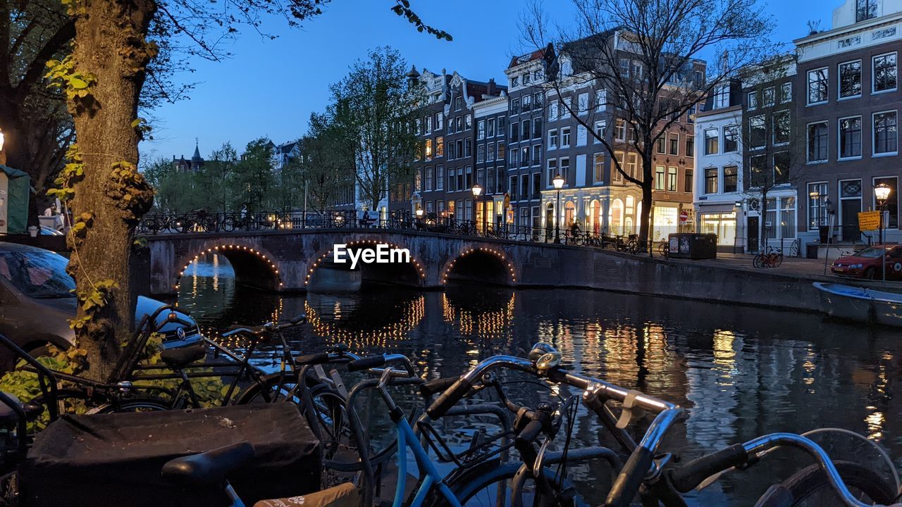 Amsterdam canal with lights around bridge