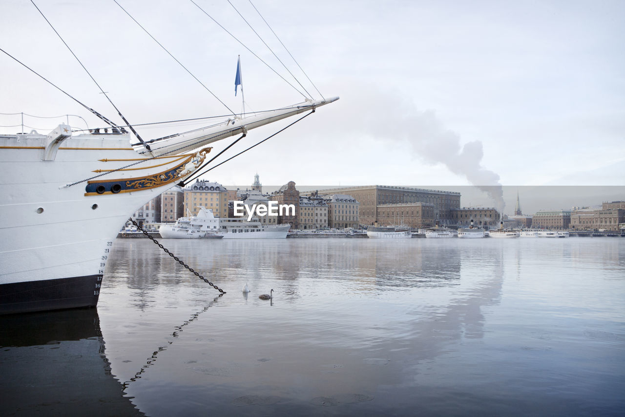 Moored ship with city on background