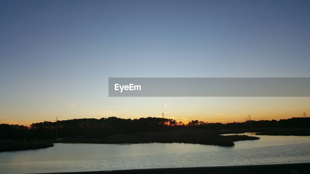 SCENIC VIEW OF SUNSET OVER SEA