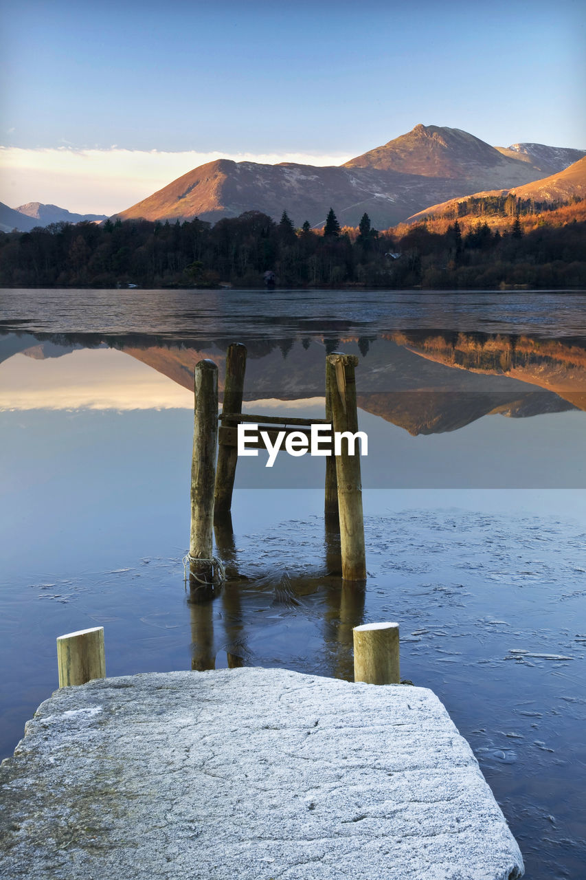 Scenic view of lake against sky during winter