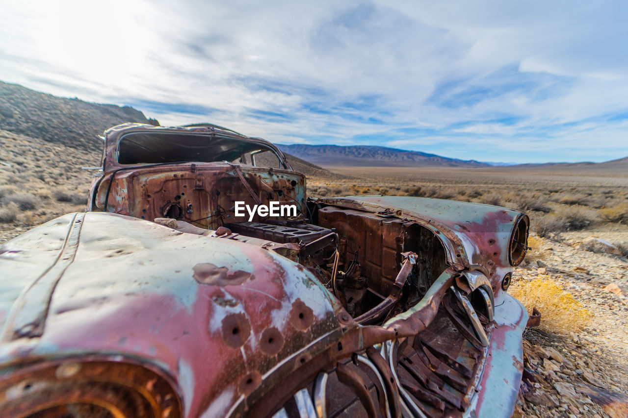 OLD ABANDONED CAR ON LAND