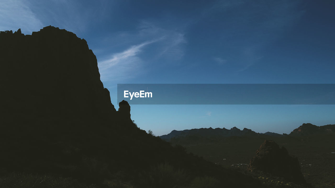 LOW ANGLE VIEW OF SILHOUETTE ROCK FORMATIONS AGAINST SKY