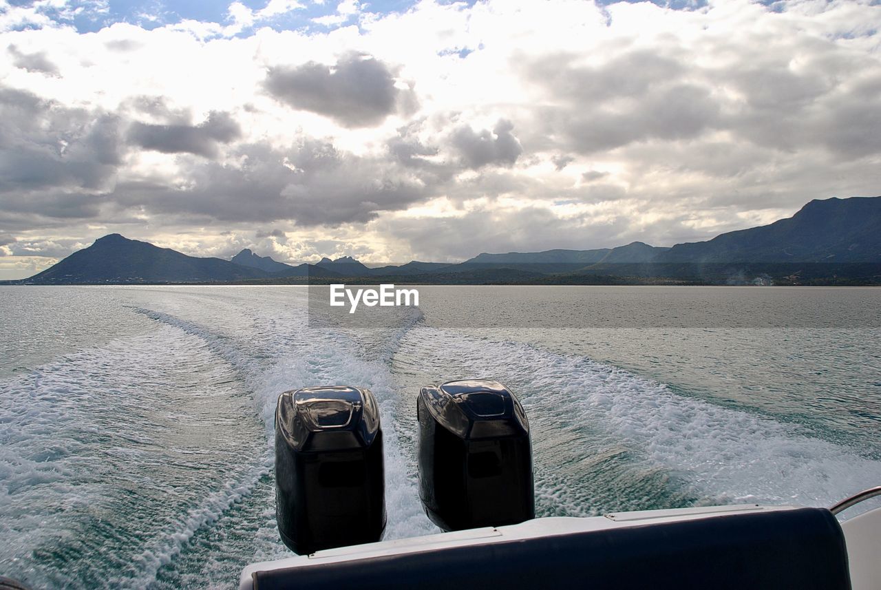 BOAT IN LAKE AGAINST SKY