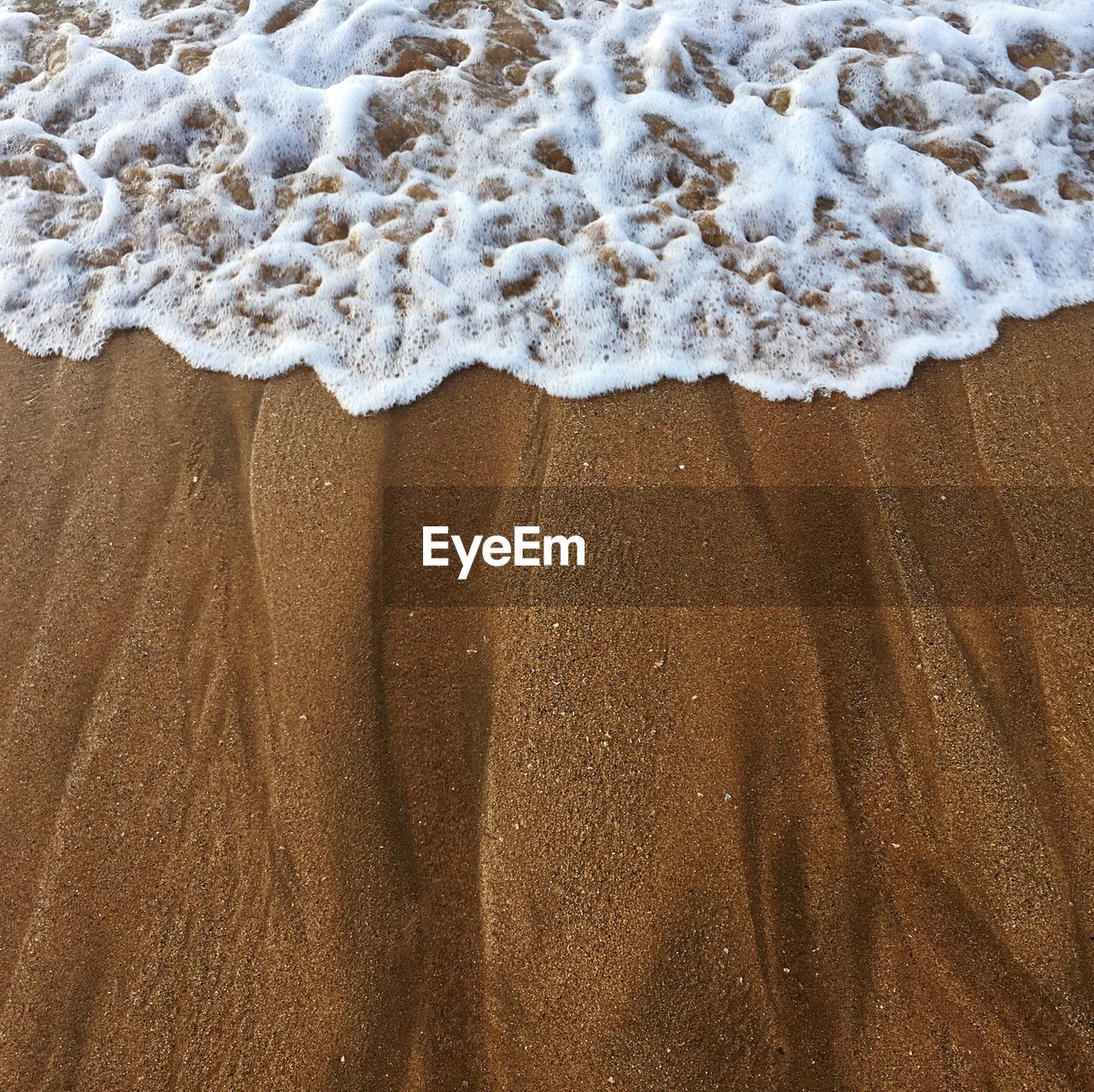 High angle view of surf on beach