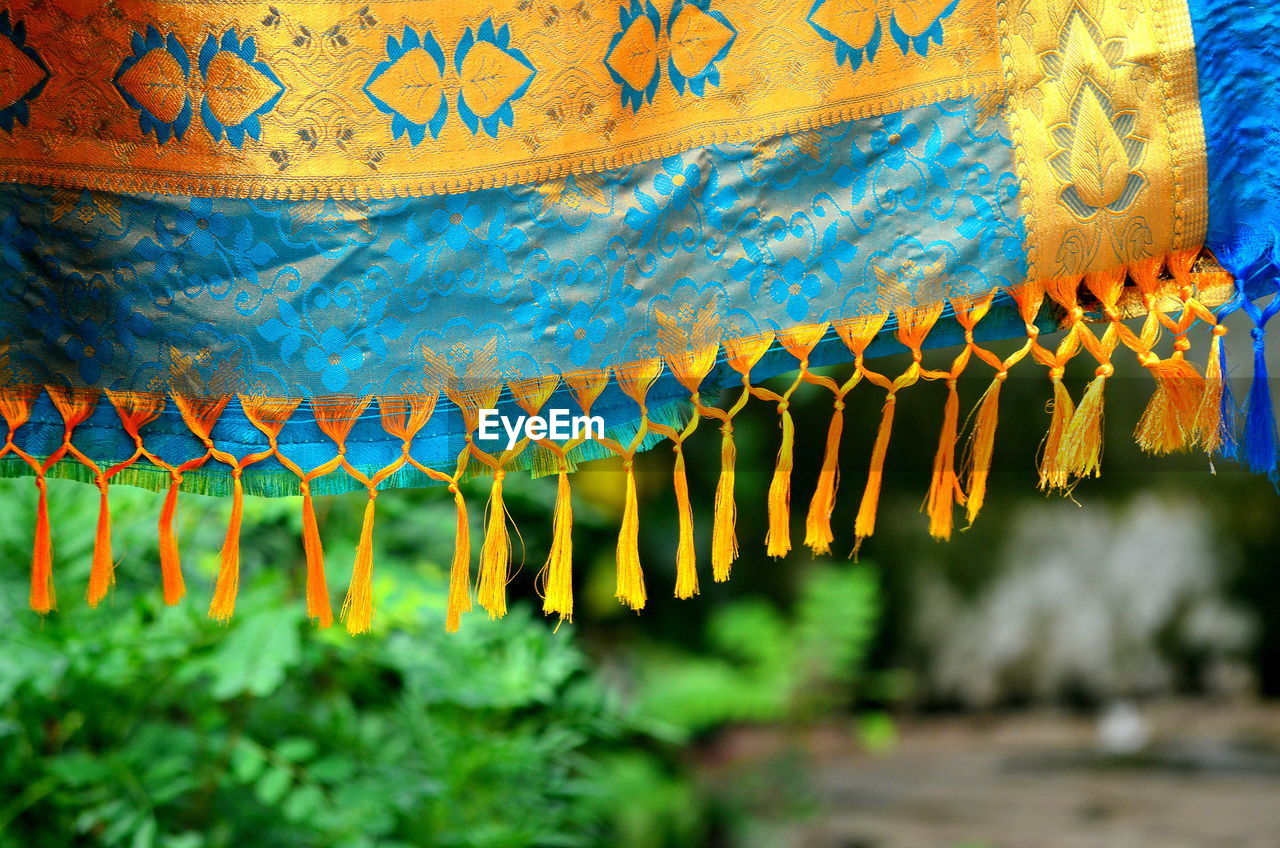 Fabric hanging against plants on field