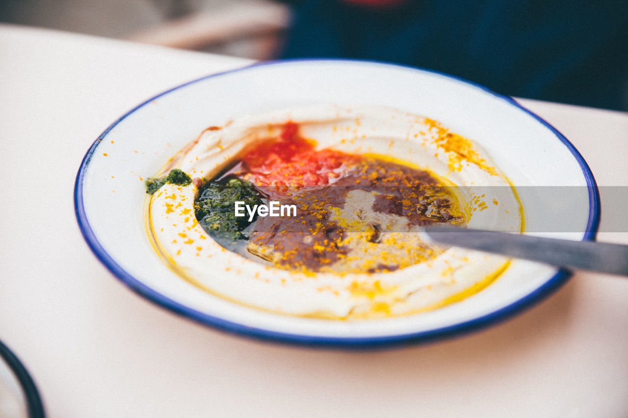 High angle view of hummus plate on table