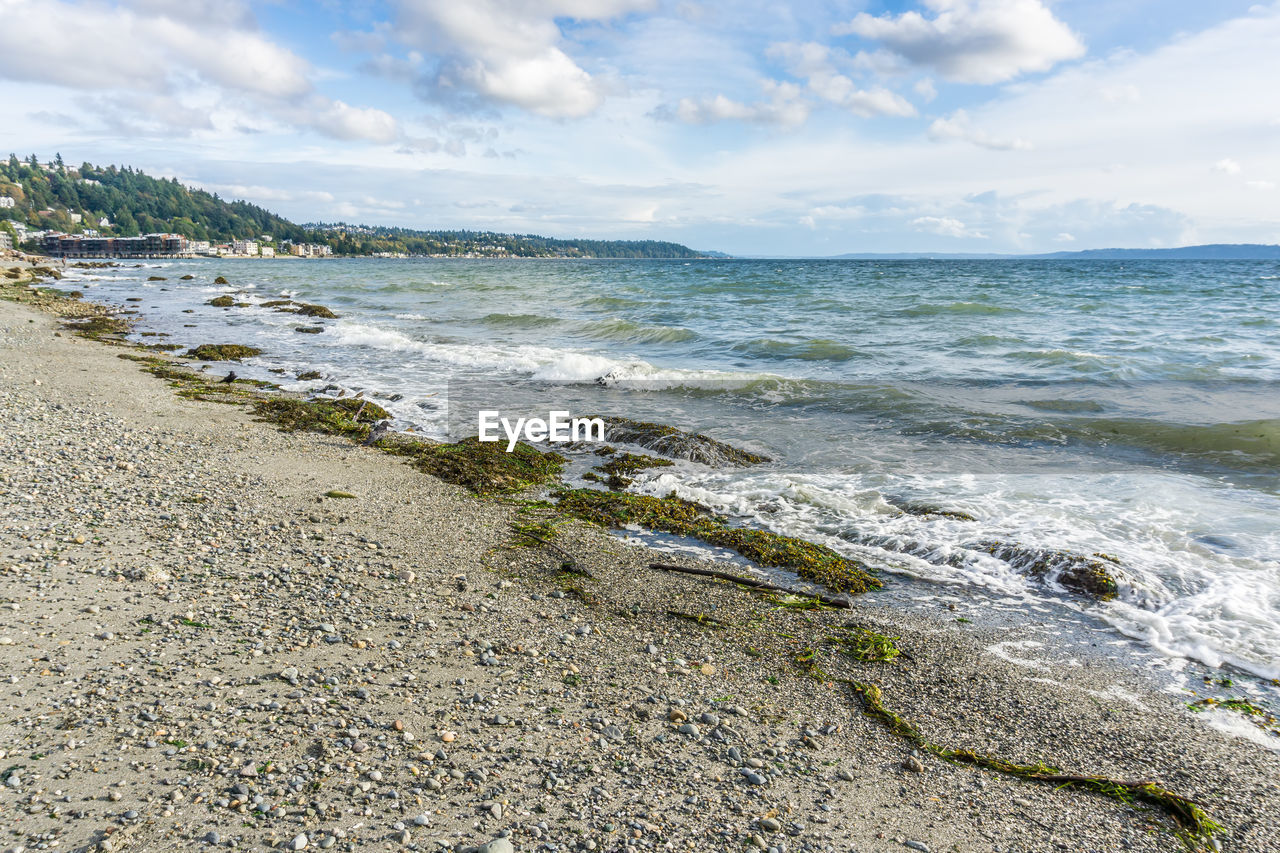 Waves roll toward the west seattle shoreline.