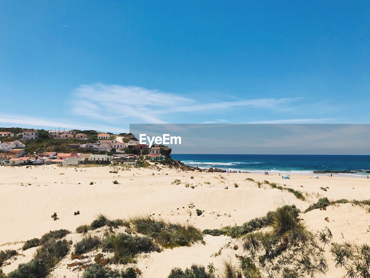 Scenic view of beach against blue sky