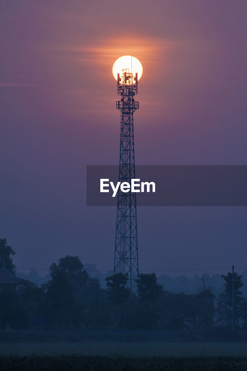 LOW ANGLE VIEW OF TOWER AGAINST SKY DURING SUNSET