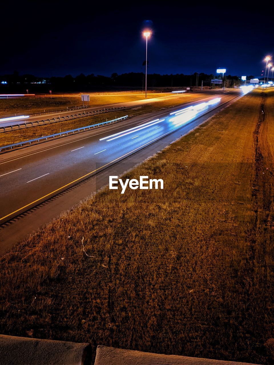 LIGHT TRAILS ON ROAD IN CITY