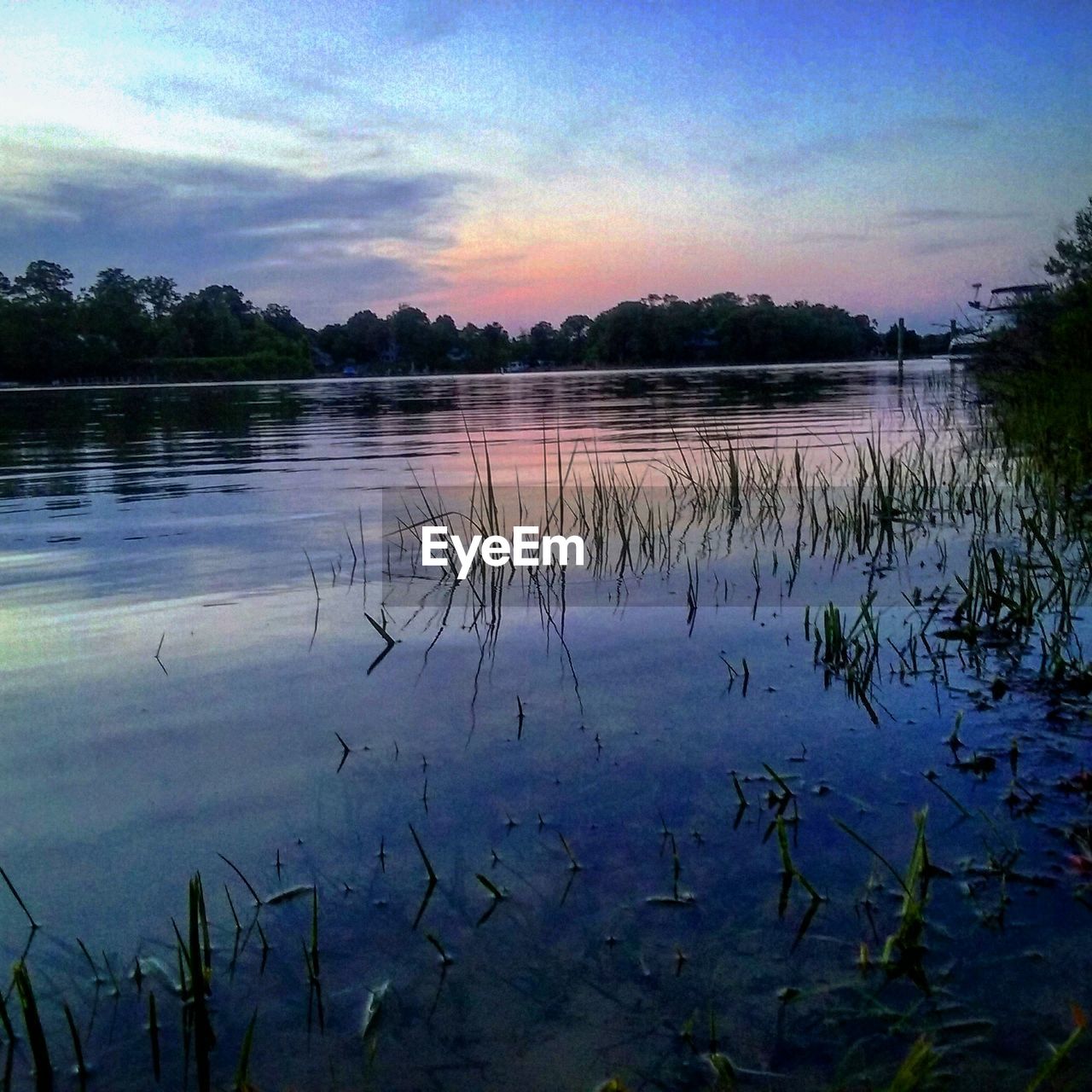 Scenic view of lake at sunset