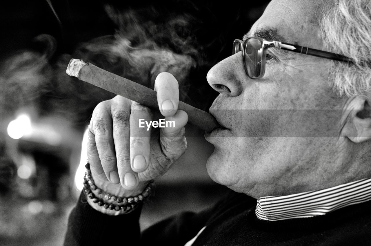 Close-up of man smoking cigar