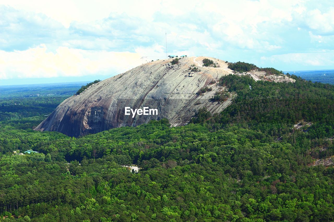 Scenic view of cliff by sea against sky