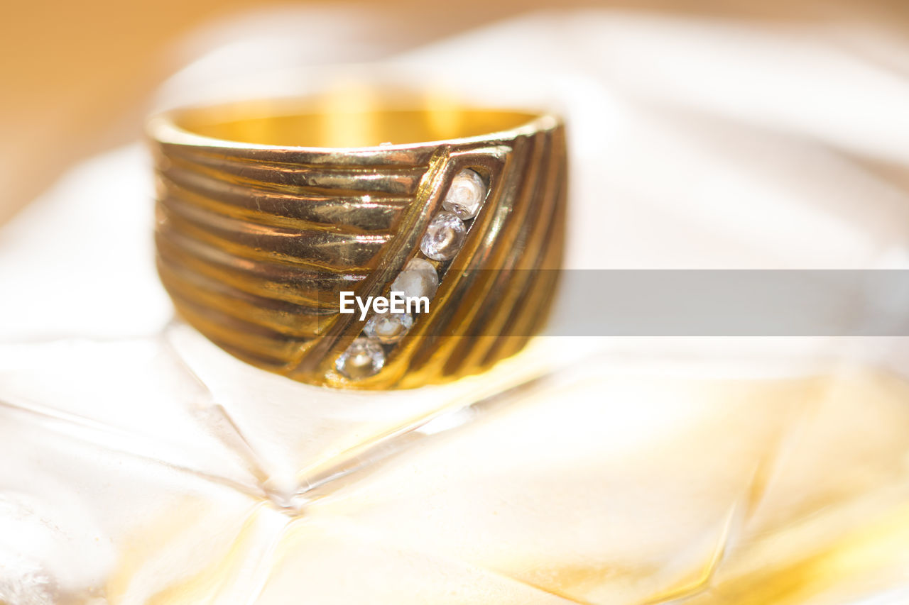 Close-up of gold ring on table