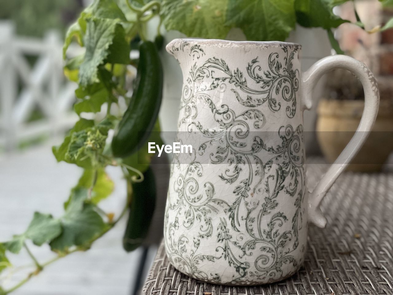 pattern, food and drink, floral pattern, drink, ceramic, mug, pitcher - jug, cup, plant, plant part, leaf, nature, no people, focus on foreground, tea cup, refreshment, flower, porcelain, art, close-up, indoors, freshness, food, coffee cup, tea, table, jug, tableware, green, craft, hot drink, ornate, wellbeing