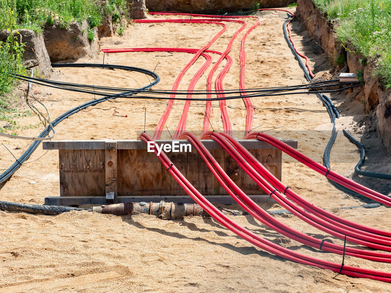 Large cables with strong electrical insulation lay underground near the distribution building