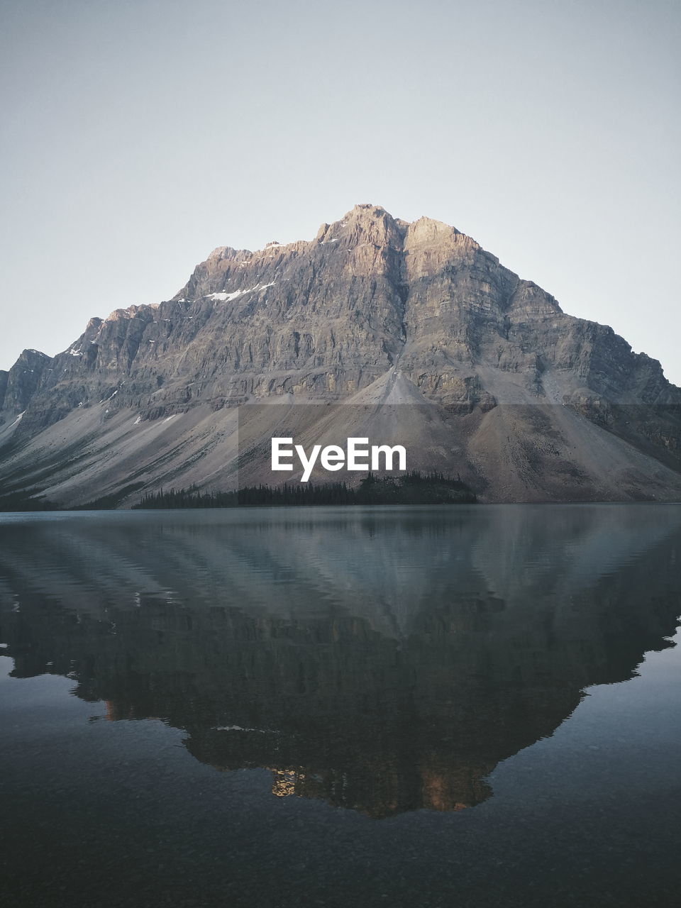 Scenic view of lake and mountains against clear sky