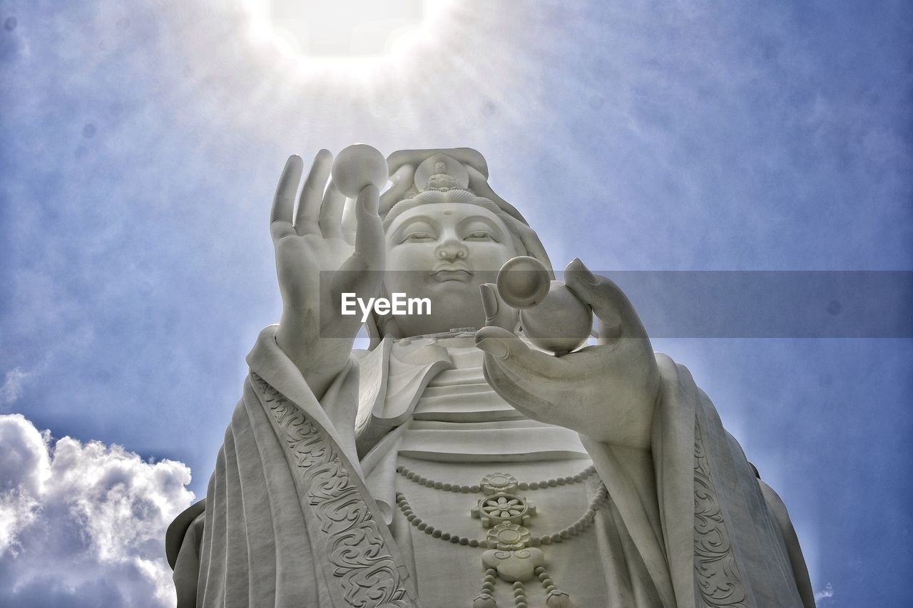 LOW ANGLE VIEW OF STATUE AGAINST SKY AND CLOUDS