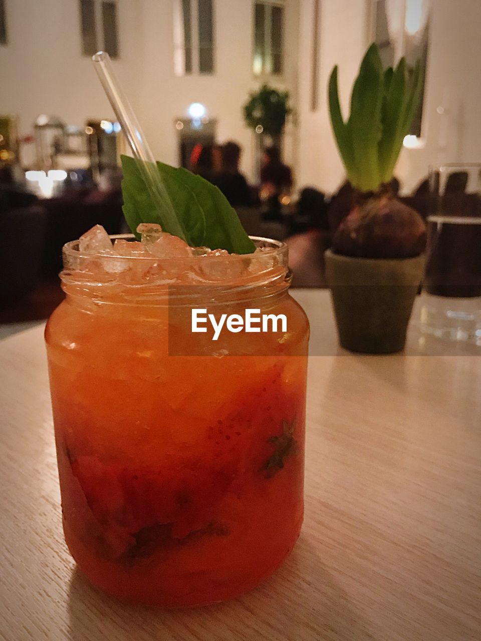 CLOSE-UP OF ICE CREAM WITH JUICE ON TABLE