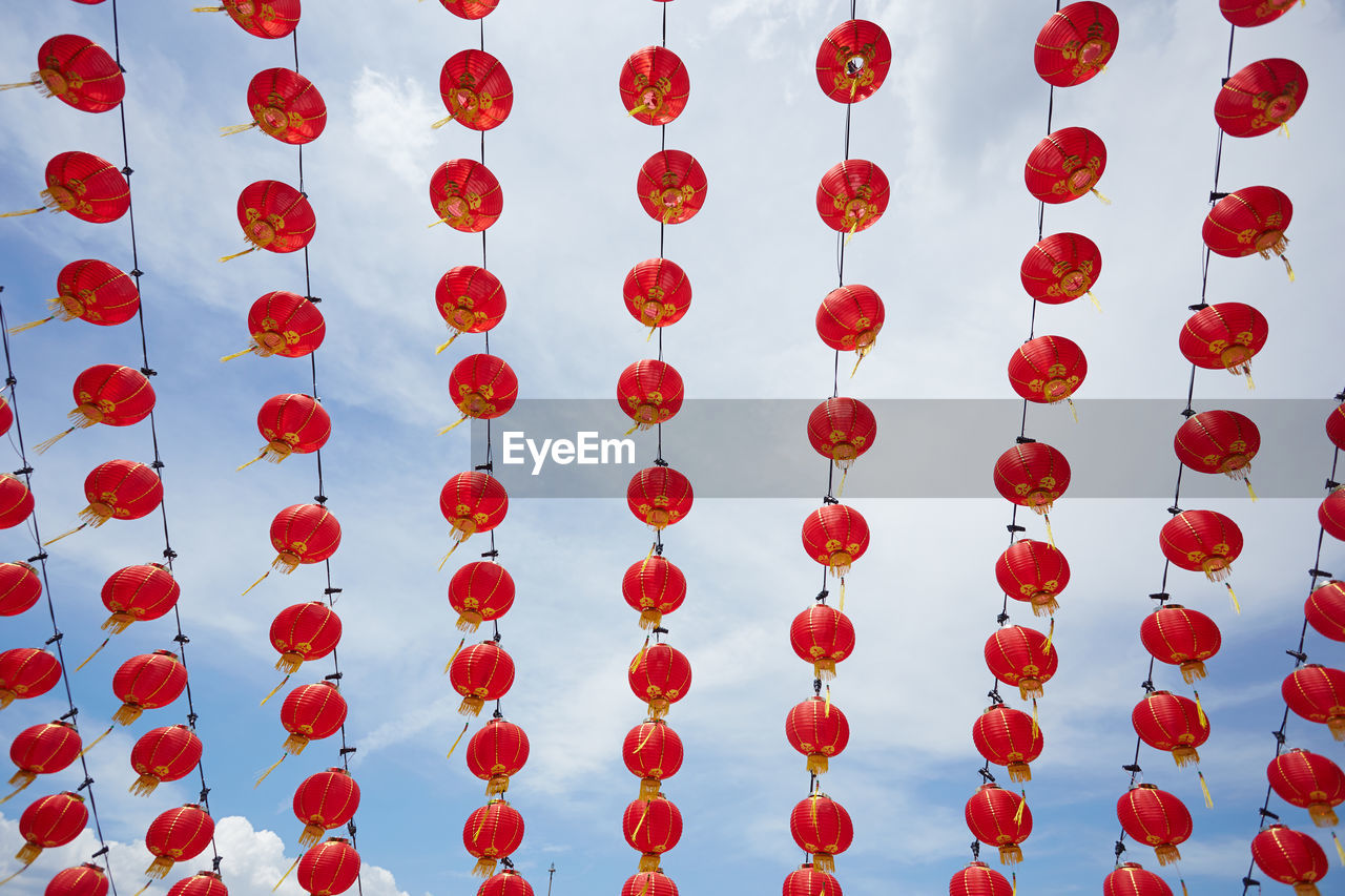 Low angle view of chinese lanterns hanging against sky