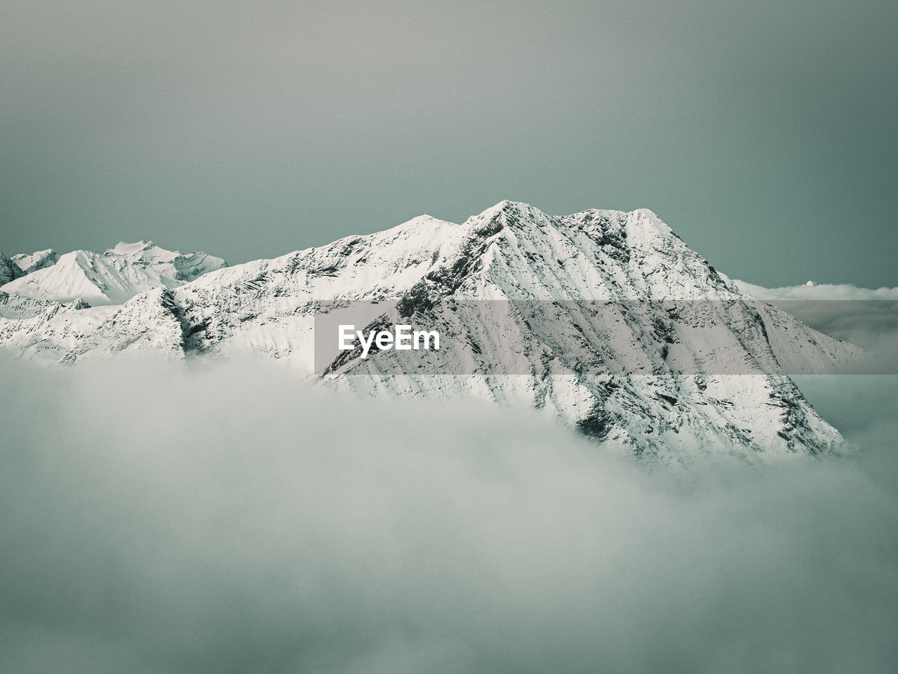 SNOW COVERED MOUNTAINS AGAINST SKY