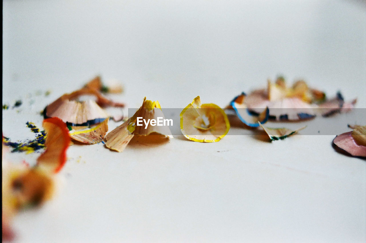 Close-up of pencil shavings against white background