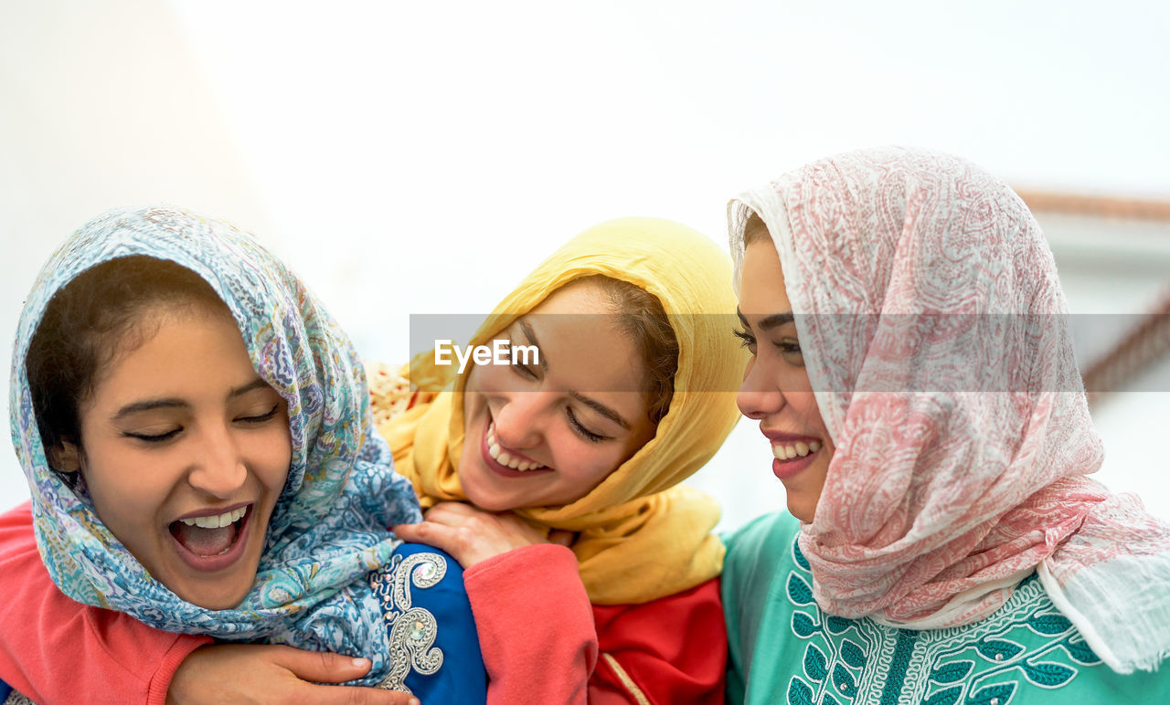 Smiling female friends smiling outdoors