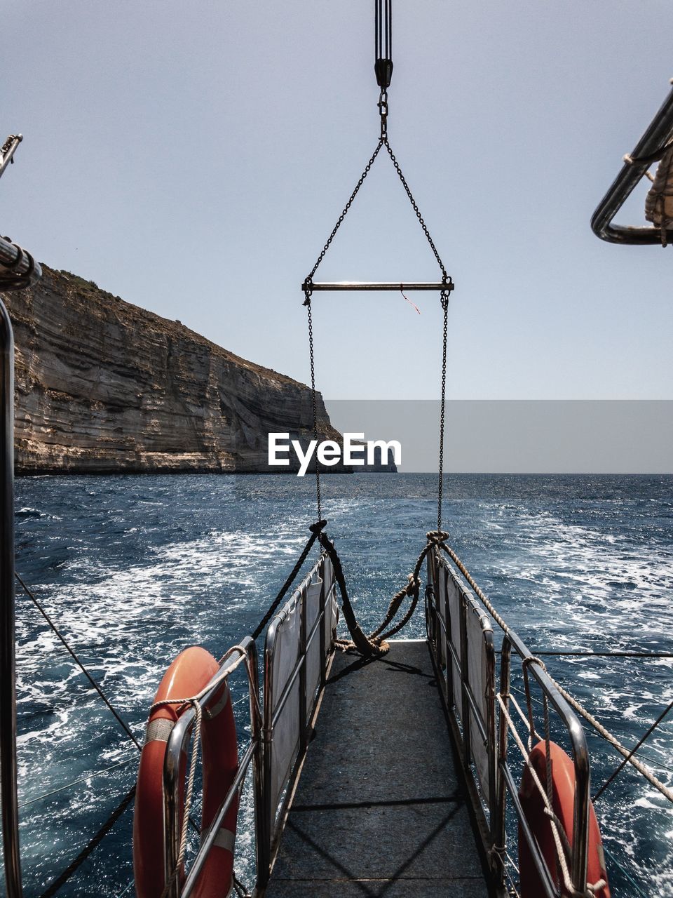 Sailboat on sea against clear sky