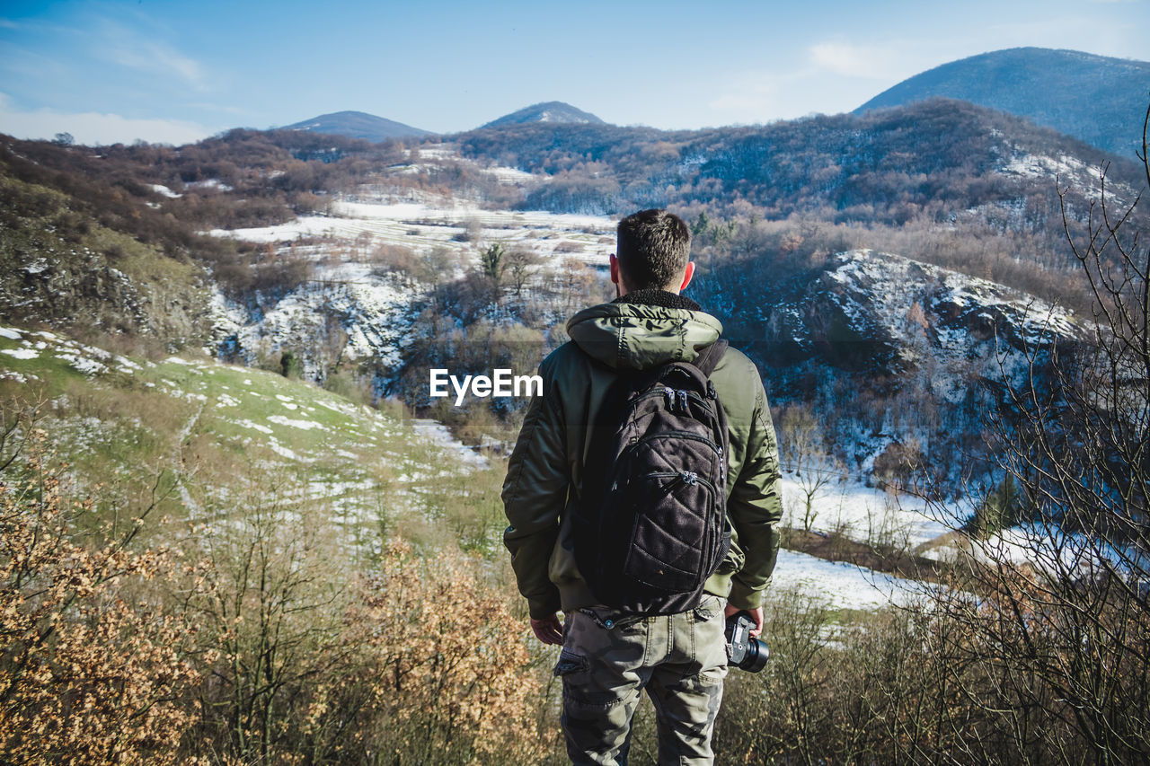 Man standing on mountains against sky