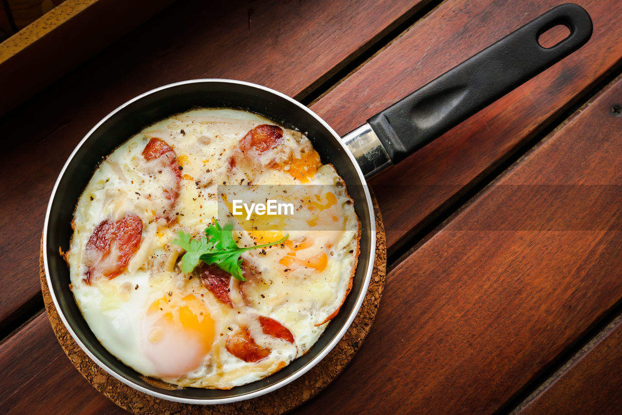 High angle view of fried egg in pan on table