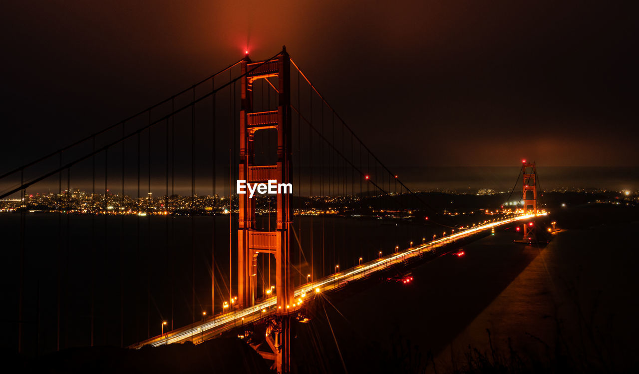 Golden gate bridge against sky at night