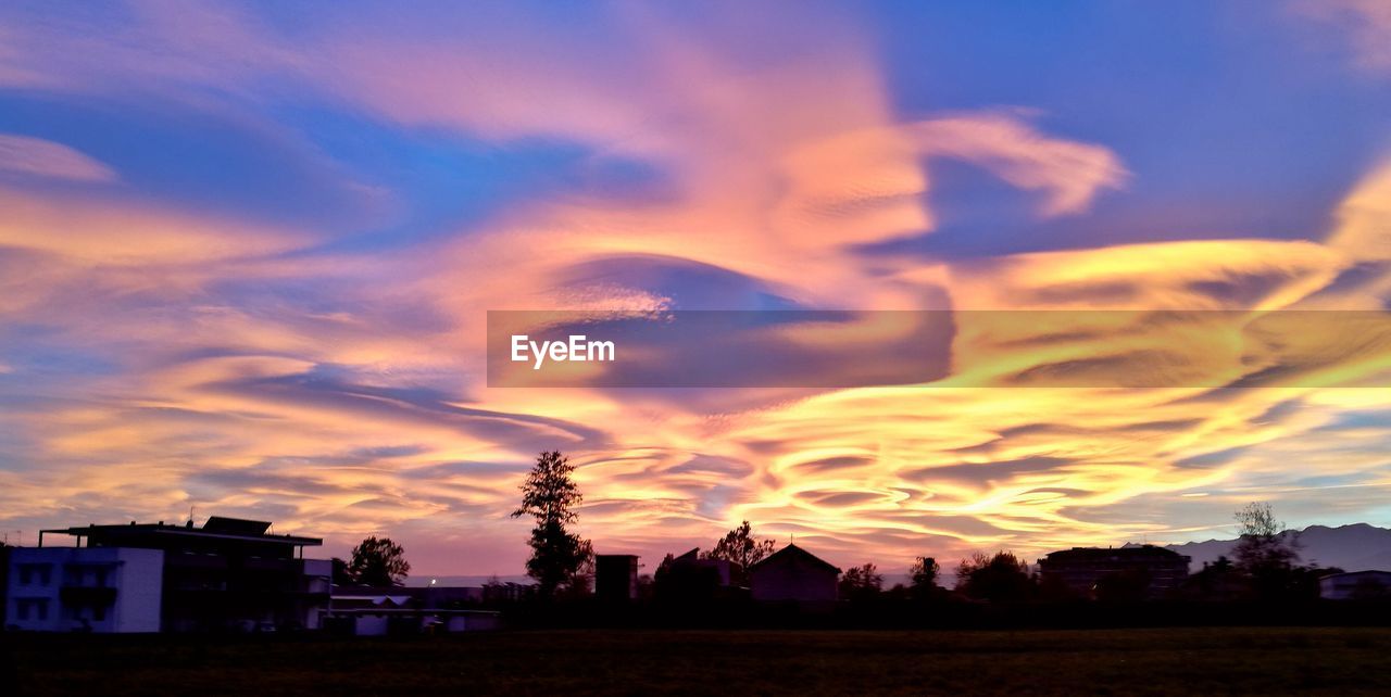 SCENIC VIEW OF DRAMATIC SKY DURING SUNSET