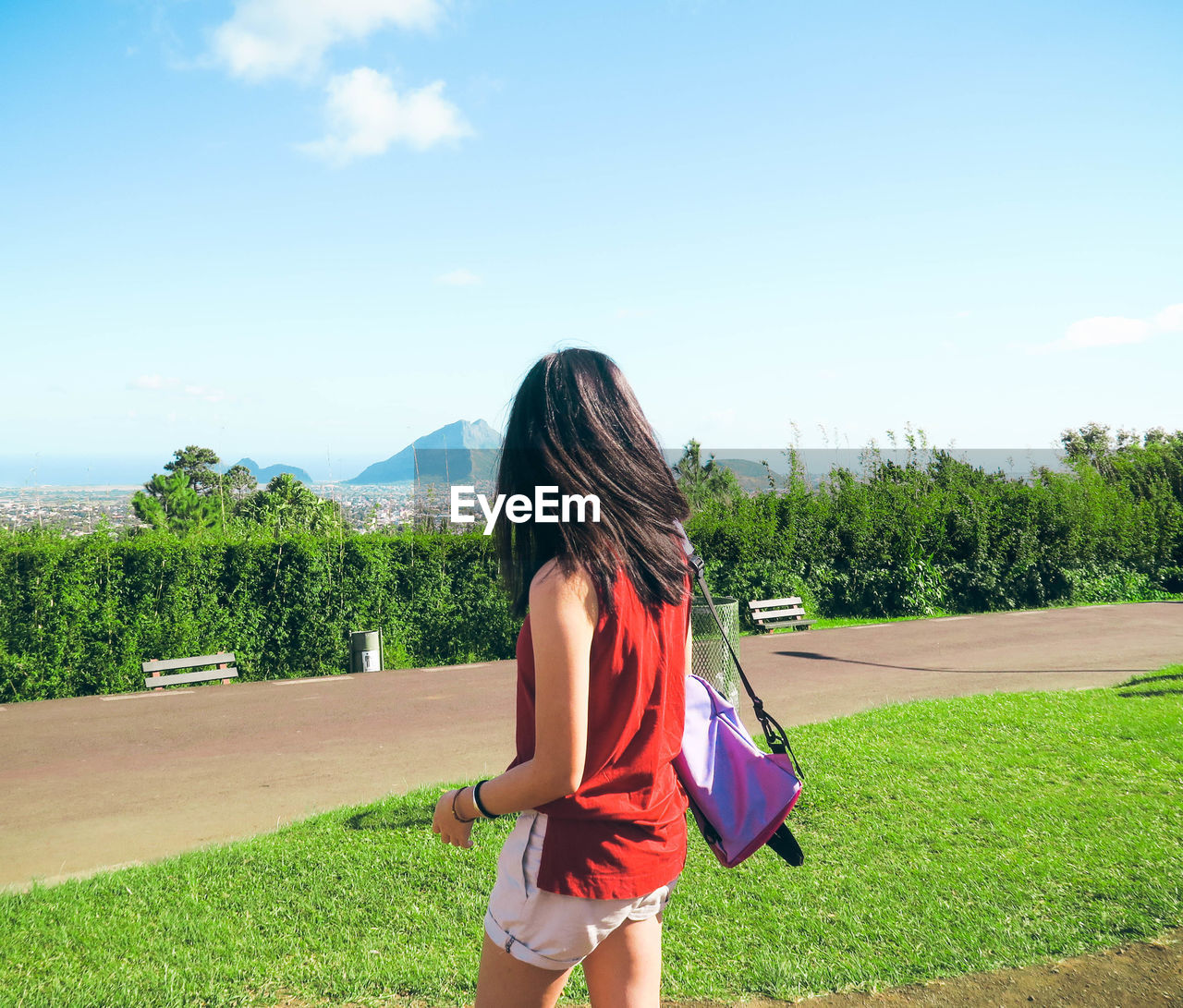 Woman standing on field against sky