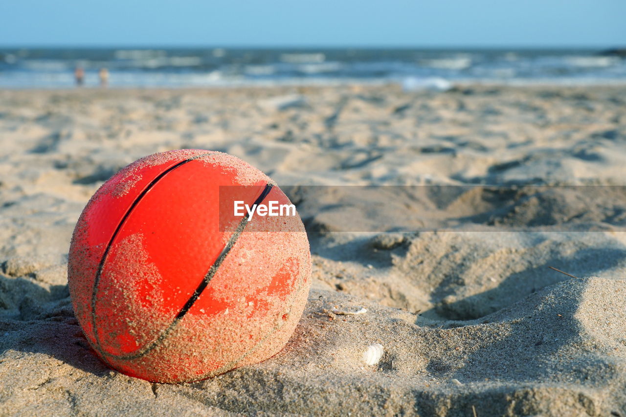 CLOSE-UP OF BALL ON SAND
