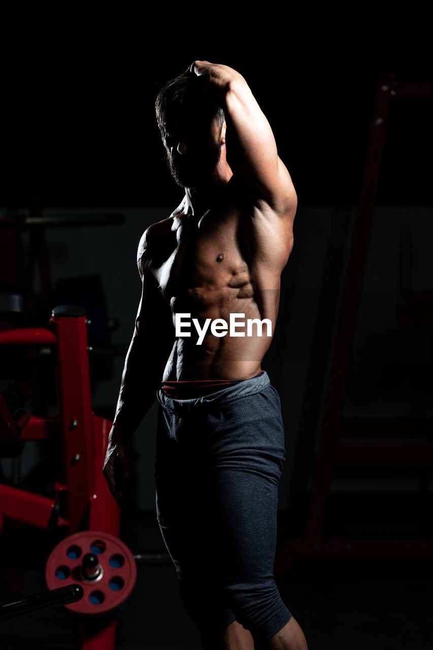 side view of woman exercising in gym