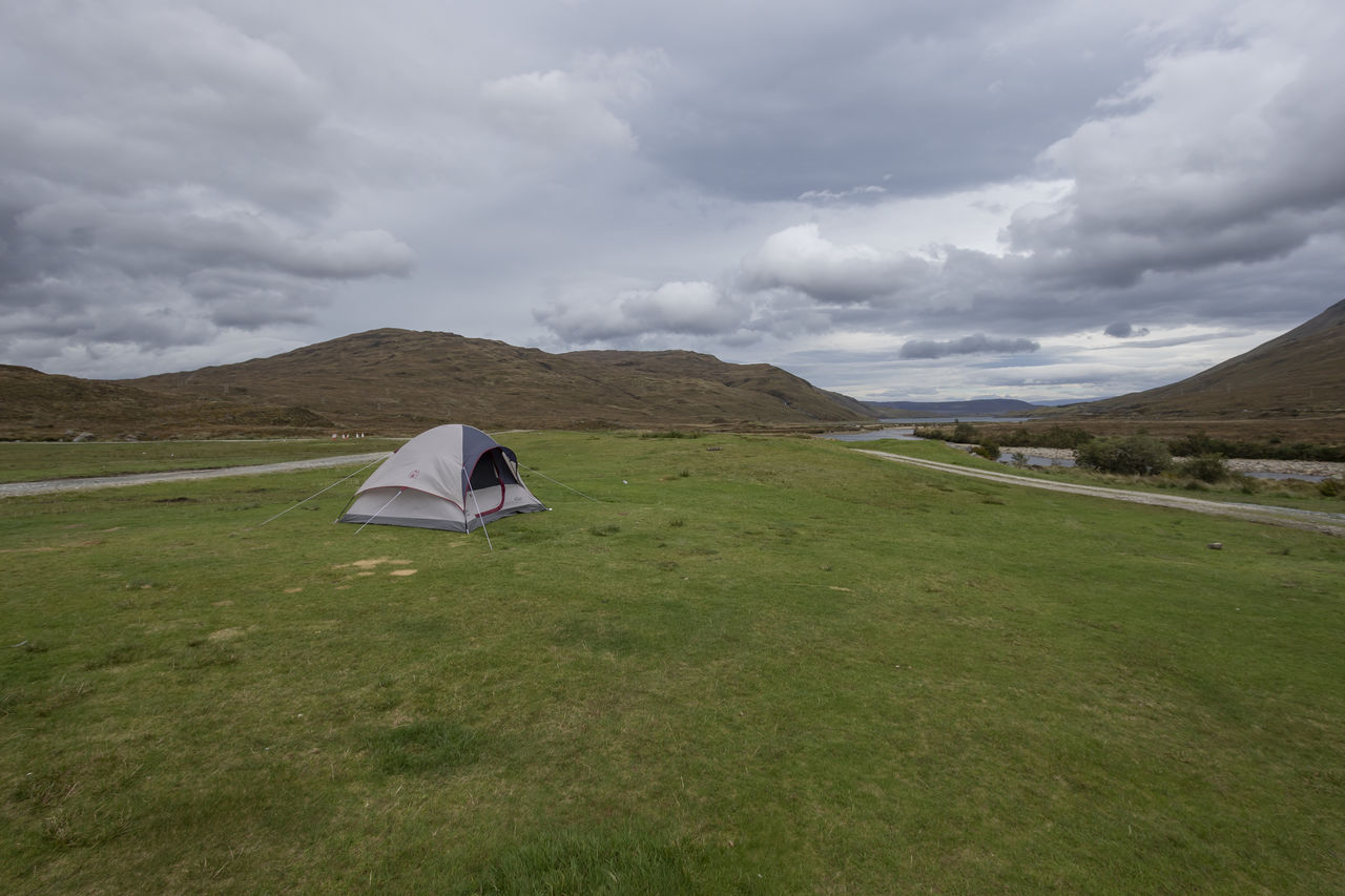 TENTS ON FIELD AGAINST SKY