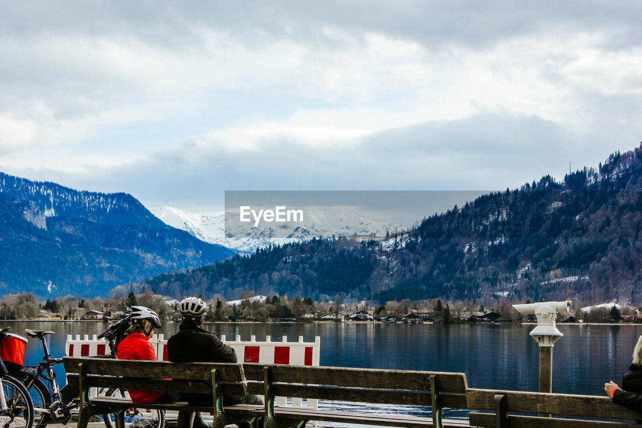 Scenic view of lake by snowcapped mountains against sky