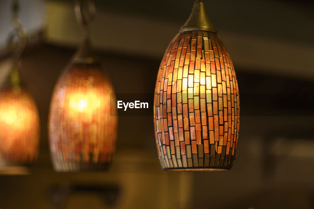 Close-up of illuminated pendant lights at home