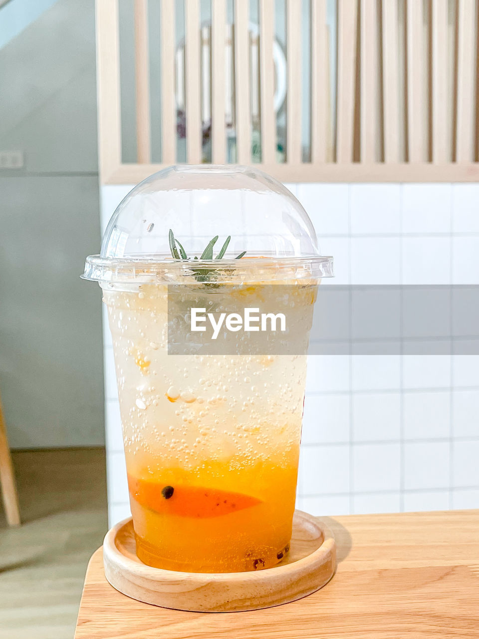 CLOSE-UP OF DRINK ON GLASS TABLE