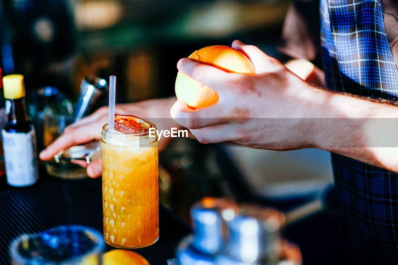 CLOSE-UP OF HAND HOLDING ICE CREAM WITH DRINK