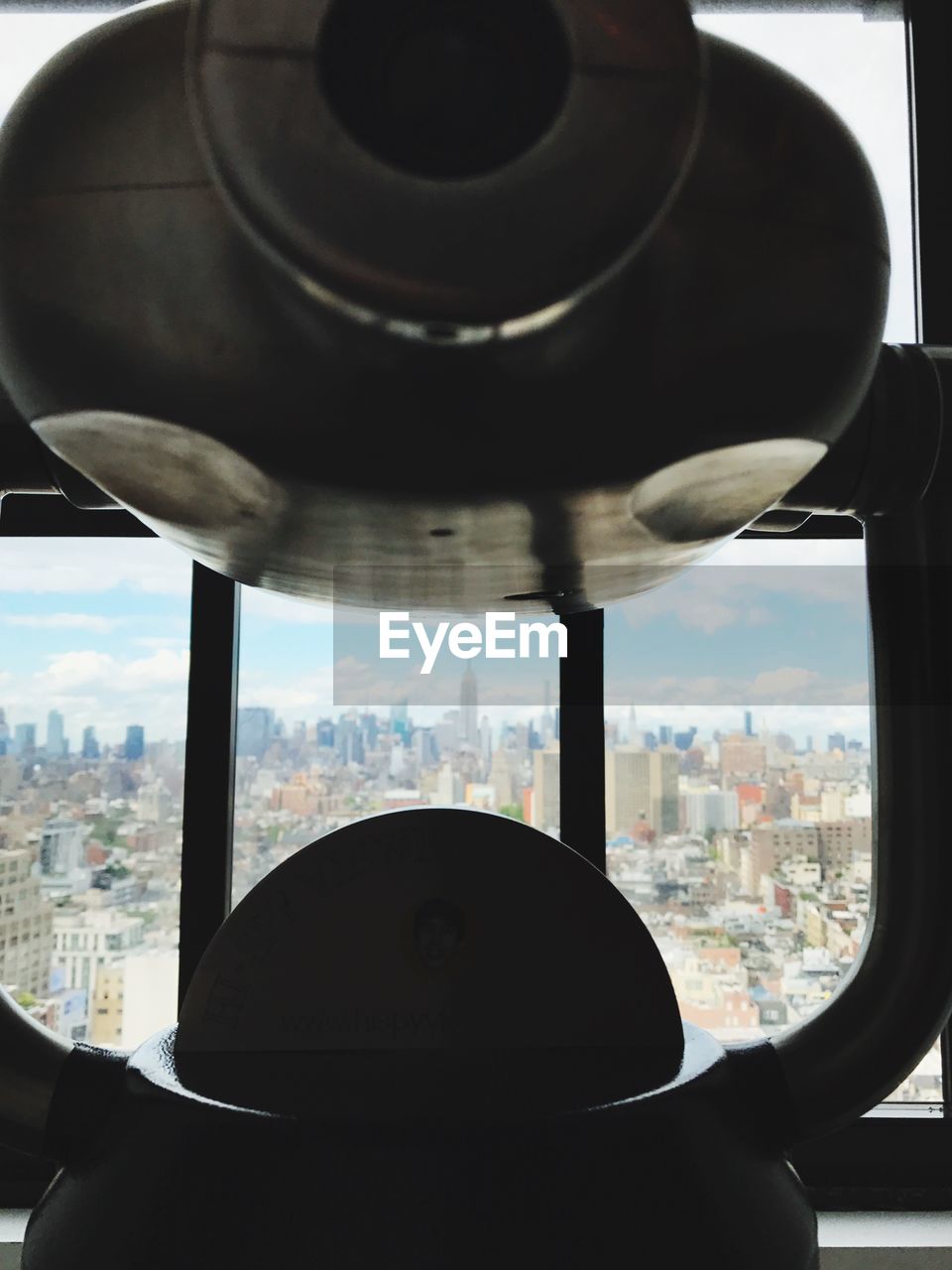 CLOSE-UP OF AIRPLANE WINDOW AGAINST SKY