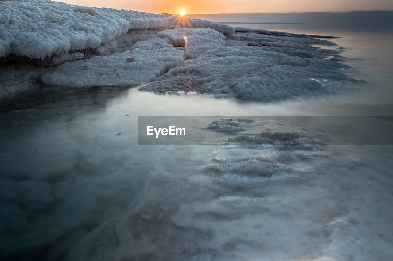 Sunset at the lowest point in the earth in the dead sea , where located in south of jordan