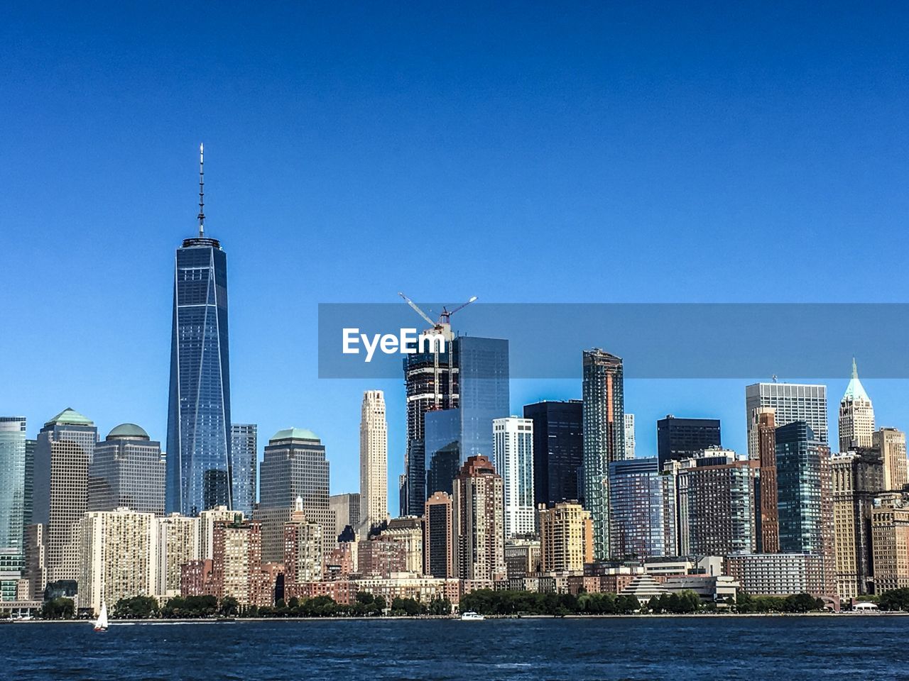 Modern buildings in city against clear blue sky