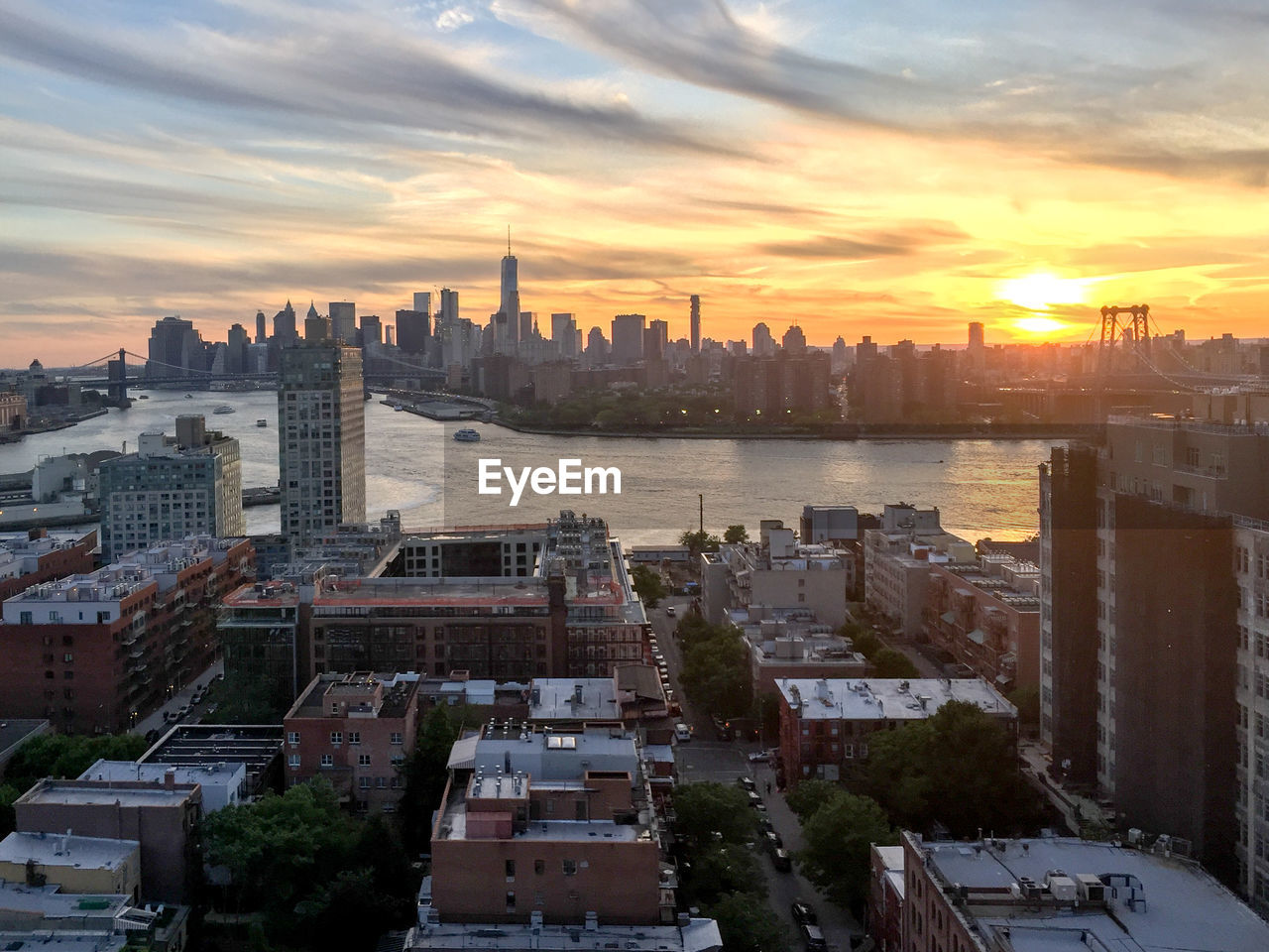 High angle view of buildings in city against sky during sunset