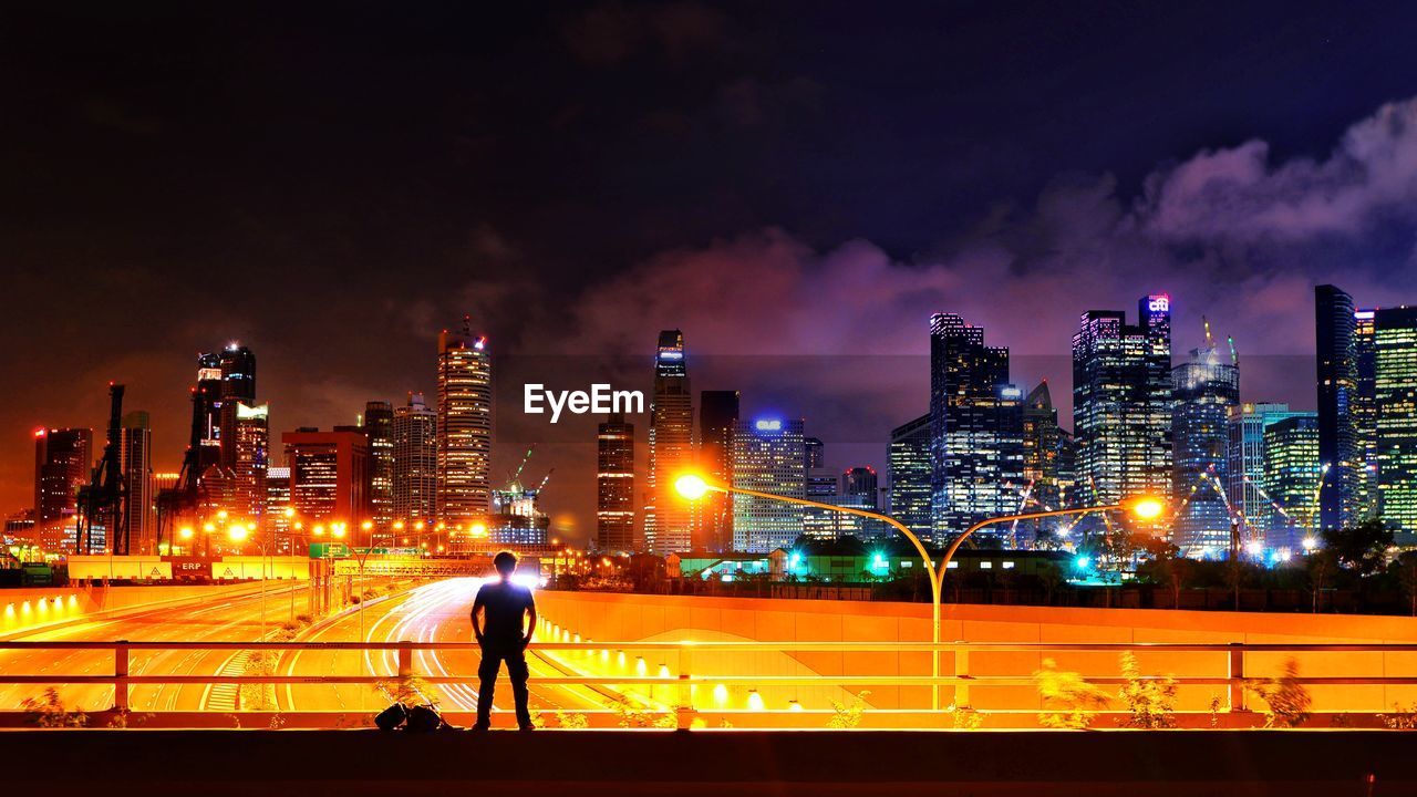 Full length of illuminated city against sky at night