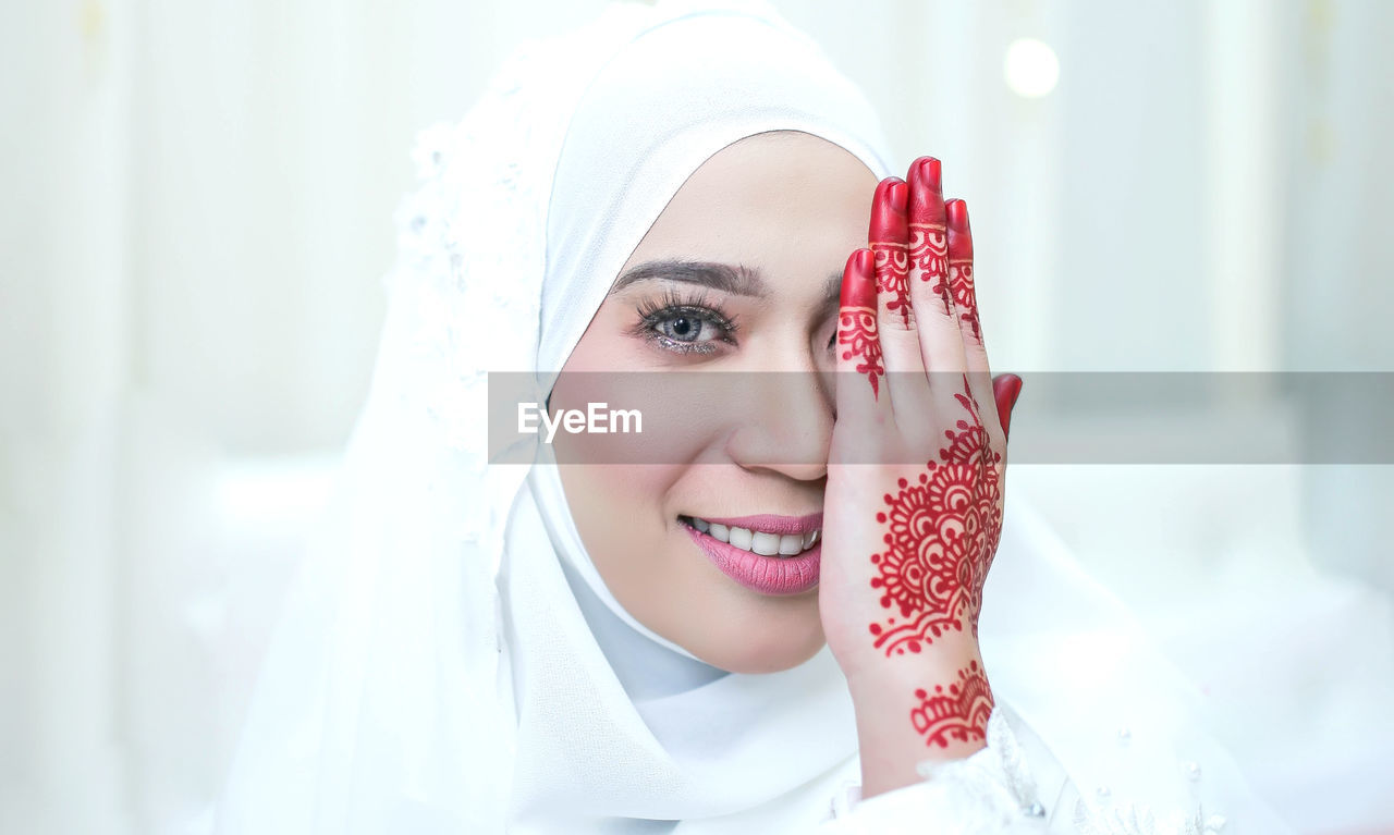 Portrait of young woman with henna tattoo