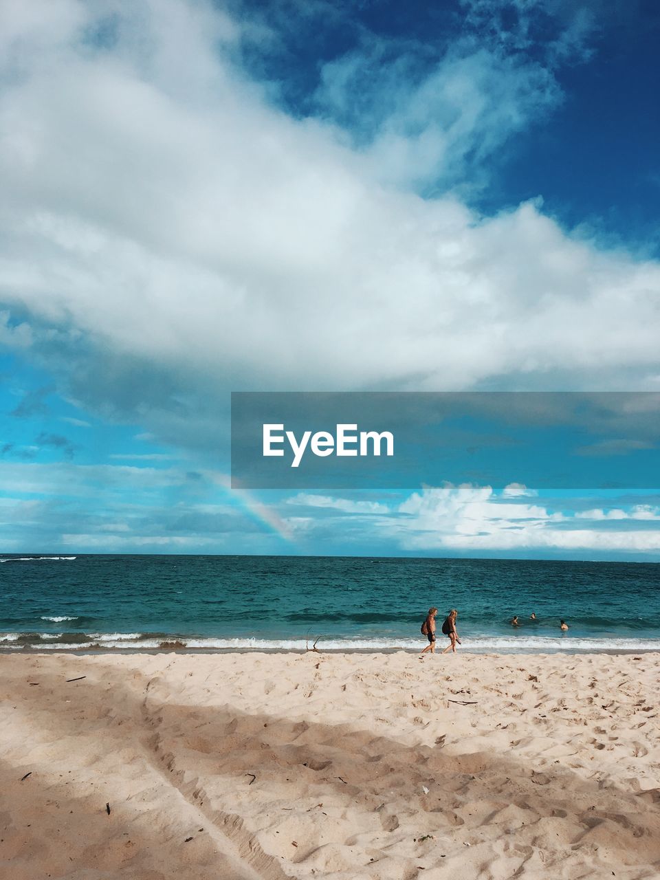 PEOPLE ON BEACH AGAINST SKY