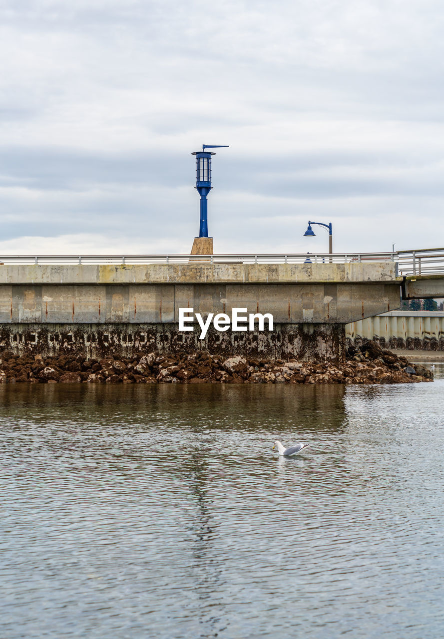 water, architecture, built structure, sea, sky, reflection, pier, cloud, building exterior, nature, day, waterfront, no people, coast, bridge, waterway, shore, outdoors, breakwater, channel, lighthouse, transportation, tower, building