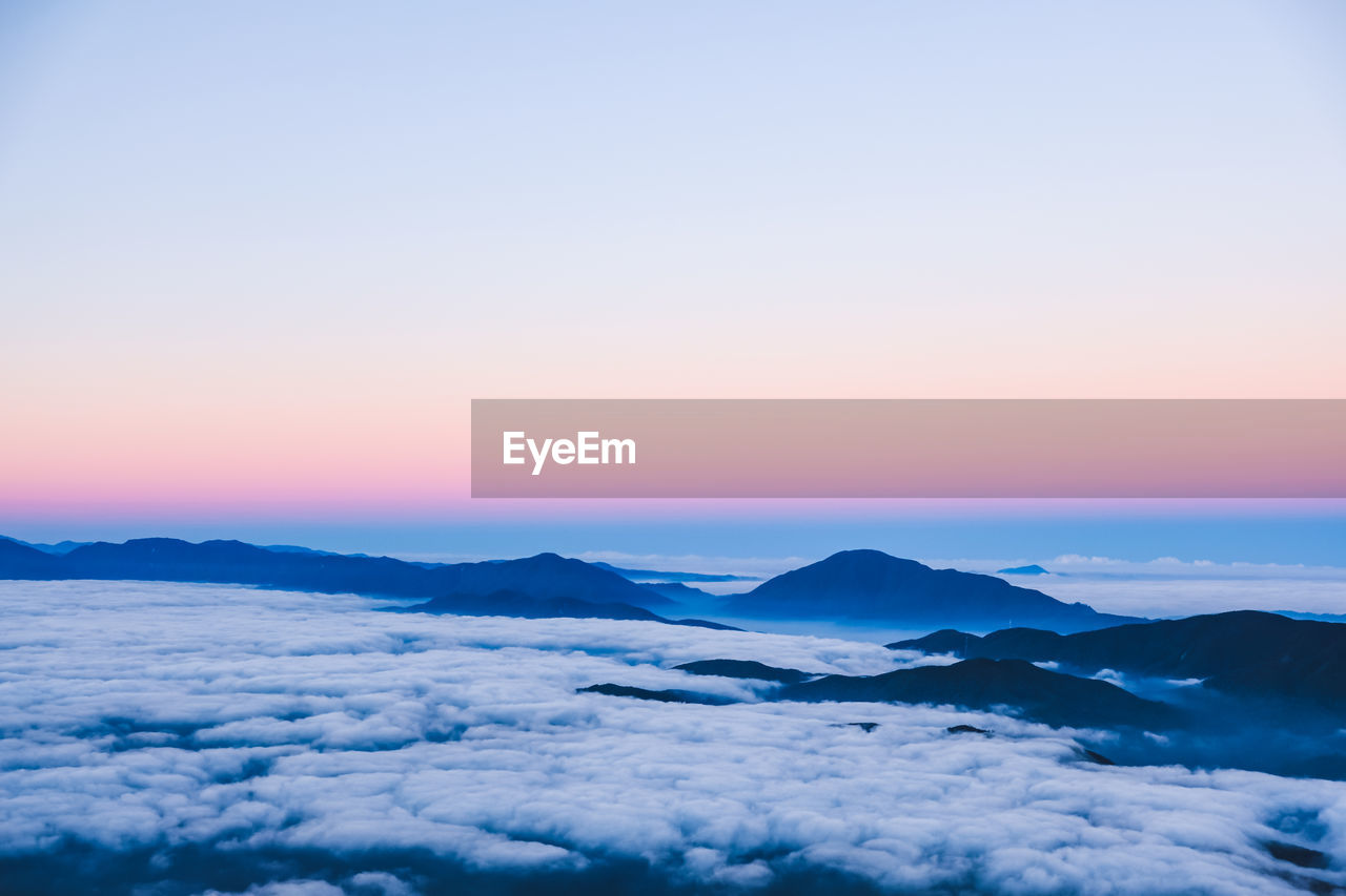 Scenic view of snow mountains against sky during sunset