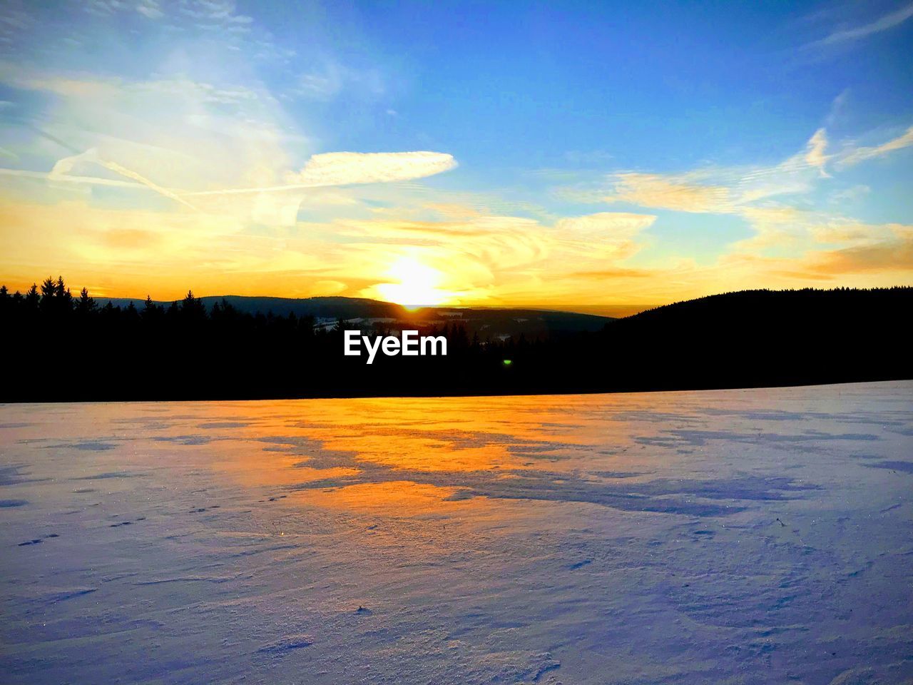 SCENIC VIEW OF SILHOUETTE LANDSCAPE AGAINST ORANGE SKY